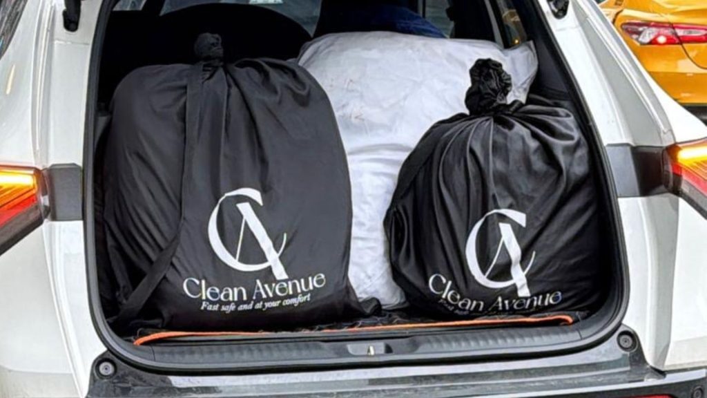 Laundry bags in Clean Avenue delivery car, ready for delivery in NYC